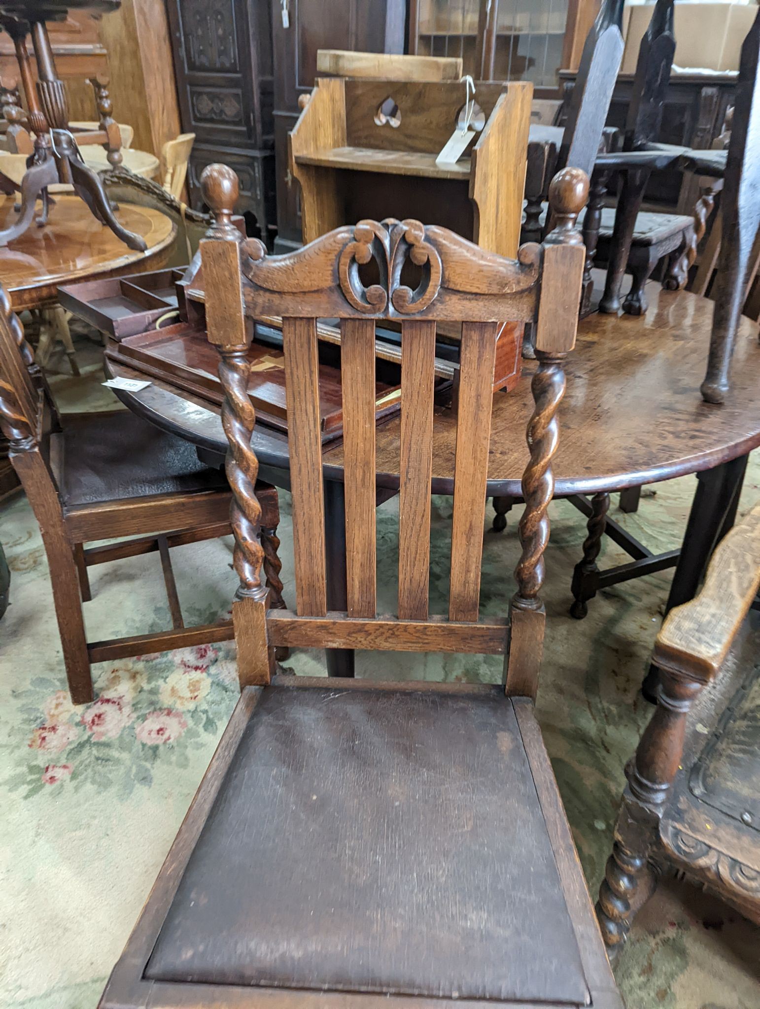 A harlequin set of six early 20th century oak dining chairs, two with arms